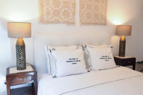 a bedroom with a bed with pillows and two lamps at PH in Alto Douro Vinhateiro 