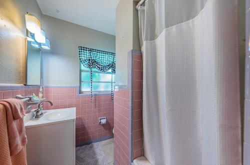 a bathroom with a shower curtain and a sink at Tropical Blue Water beachside 7 in Clearwater Beach