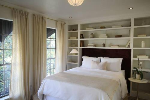 a bedroom with a large bed and a large window at Mr. Nomad: Artistic Abode in Uptown in Dallas