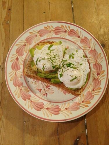 a plate with a sandwich with two eggs on it at Michaelmas Cottage Upavon in Upavon