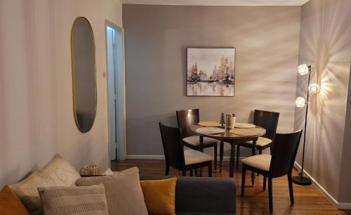 a living room with a table and a dining room at 2p lumineux au Cœur de Strasbourg in Strasbourg
