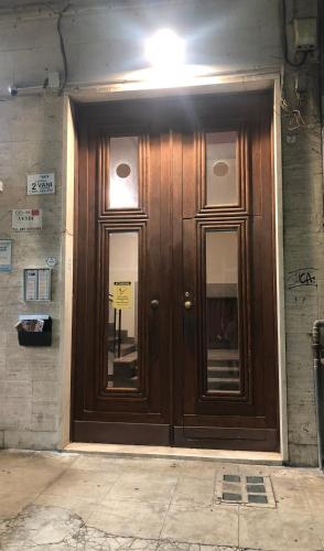 a wooden door on the side of a building at G&G ROOMS in Palermo