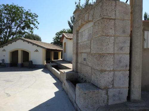 a stone wall in front of a house at Casa rural Bisimbre in Bisimbre