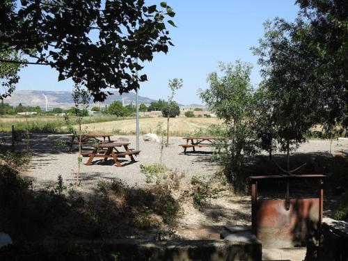 a group of picnic tables in a field at Casa rural Bisimbre in Bisimbre