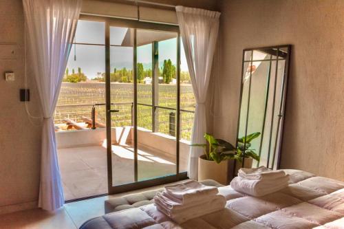 a bedroom with a bed and a large window at Agrelo Vines Lodge in Agrelo