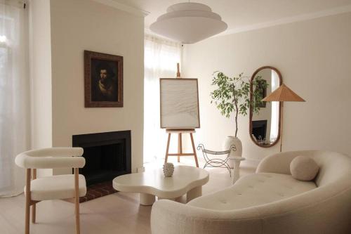 a living room with a couch and a chair at Mr. Nomad: Casa Bohem in Uptown in Dallas