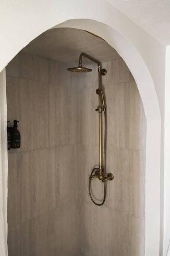 a shower in a bathroom with a shower head at Mr. Nomad: Casa Bohem in Uptown in Dallas