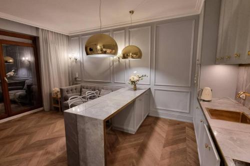 a kitchen with a large counter with flowers on it at Luxury Garden Apartment in Warsaw
