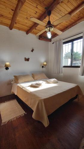 a large bed in a room with a wooden ceiling at Altos del Campo in San José