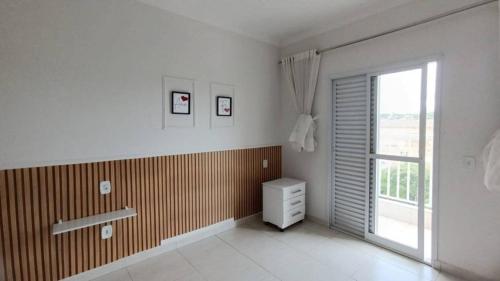 een witte kamer met een raam en een dressoir. bij CASA 2 QUARTOS in Rio de Janeiro
