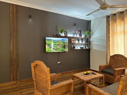 a living room with a television on a wall at Cozy private villa in Fukuchani in Mchangani