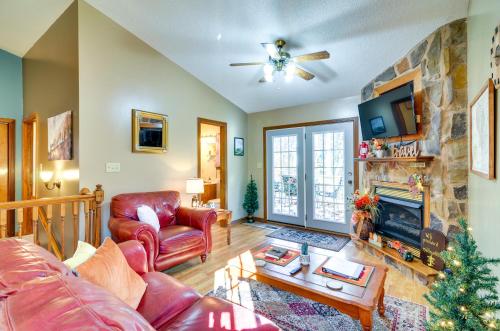 a living room with a couch and a fireplace at Burnside Resort Cabin with Hot Tub and Outdoor Spots! in Burnside