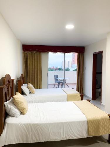 Hotel Continental Plaza Barranquillaにあるベッド