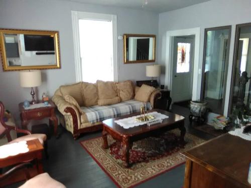a living room with a couch and a coffee table at Red Roof Home Accommodates 10 people! in Tazewell