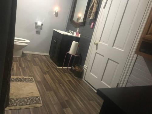 a bathroom with a toilet and a sink and a door at Red Roof Home Accommodates 10 people! in Tazewell