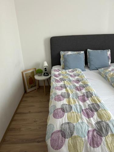 a bedroom with a bed and a table with a lamp at Apartmán "DUNAJ" private parking - klimatizácia in Šamorín