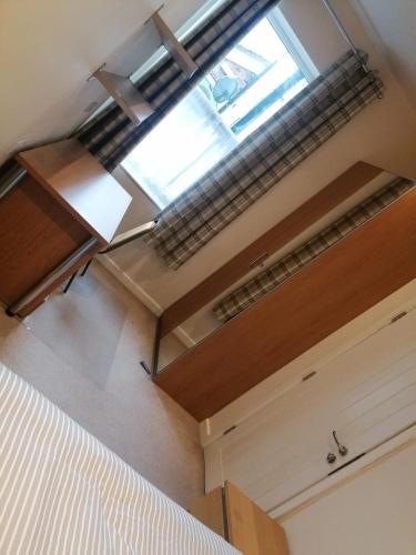 a room with a bed and a large window at Great Home of Relaxations in Stoke on Trent