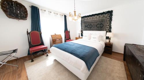 a bedroom with a large bed and a television at PH in Alto Douro Vinhateiro in Urros