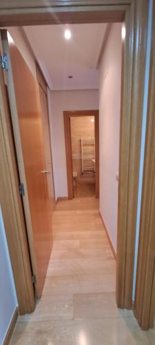 a hallway with a hallway leading to a room with a door at Habitaciones De Lujo Con Hermosas Vistas A La Cuidad in Burgos