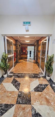 an empty hallway with a lobby with potted plants at SKY 9 Hostel ,UNION METRO in Dubai