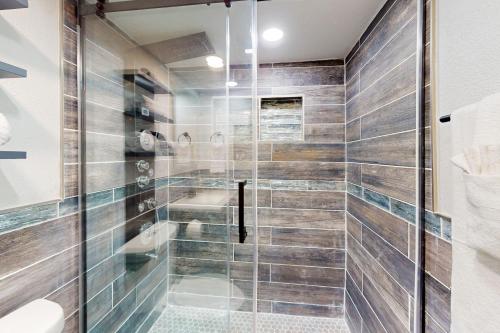 a bathroom with a shower with a glass door at Big City Living, Full Property in Dallas