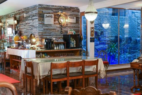a restaurant with a table and a large window at PH in Alto Douro Vinhateiro in Urros