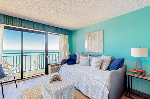 a bedroom with a bed and a view of the ocean at Making Memories in Myrtle Beach