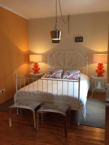 a bedroom with a white bed and two lamps at Alma N' Sleep in Almancil