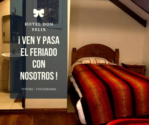a bedroom with a bed with a sign on the wall at Hotel Don Felix in Totora