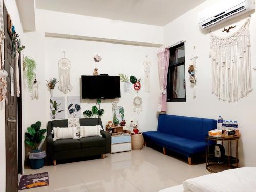 a living room with a couch and a tv at 一宿來民宿 in Fengping