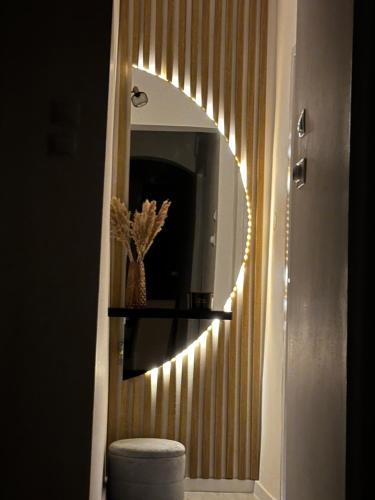 a bathroom with a mirror and a toilet with lights at Saguna Residence2 in Sighişoara