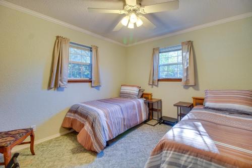 a bedroom with two beds and a ceiling fan at Private Boat Dock Family-Friendly Grove Getaway in Grove