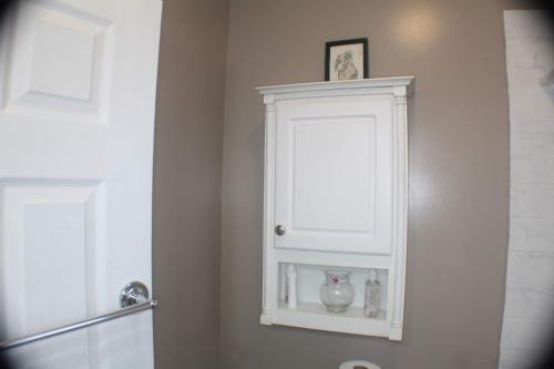a white cabinet in the corner of a bathroom at Historic West End Gem in Hartford