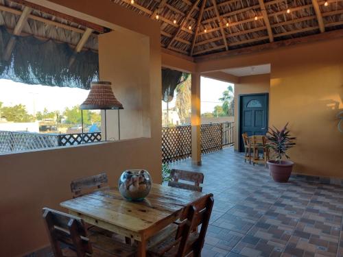 a dining room with a wooden table and chairs at Hotel Prado´s in San Carlos