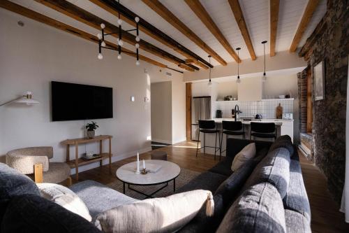a living room with a couch and a table at Maison Place Royale by Luxury In Transit in Montréal