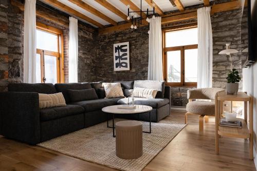 a living room with a couch and a table at Maison Place Royale by Luxury In Transit in Montréal
