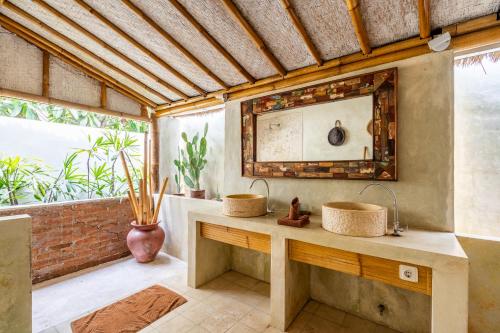 a bathroom with a sink and a mirror at Villa Burung Gili Air Authentic 3-Bedroom Bamboo Villa with Private Pool in Gili Air