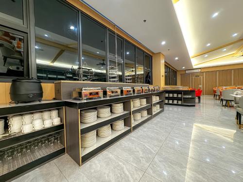 a kitchen with plates on shelves in a restaurant at Venus Royale Hotel in Coron