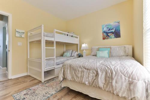 a bedroom with a bunk bed and a white bed at Ocean Club At Turtlemound 107 - 2 Bedroom 1 Bath in New Smyrna Beach
