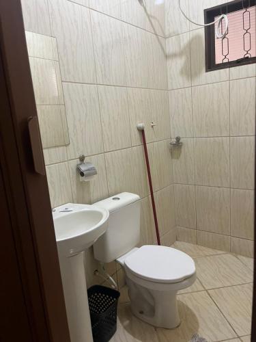 a bathroom with a toilet and a sink at Hotel Pousada Barra Bonita in Barra Bonita