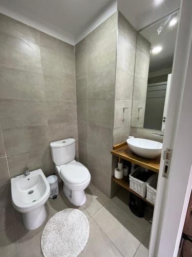 a bathroom with a toilet and a sink at Terrazas de Godoy in Godoy Cruz