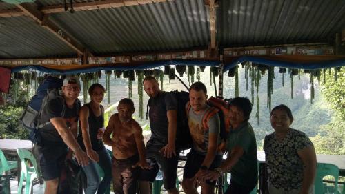 a group of people posing for a picture under a roof at BATAD Rita's Mount View Inn and Restaurant in Banaue