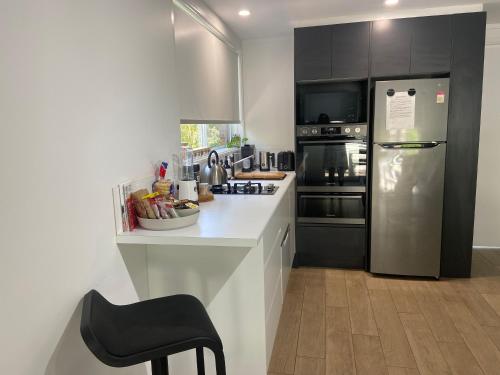 a kitchen with a stainless steel refrigerator and a counter at Conjola Inn-let - Self Contained Unit - Lake Conjola in Manyana