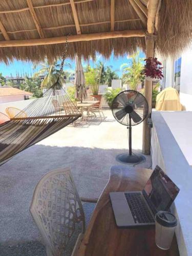 a laptop computer sitting on a hammock on a patio at LAS VUELTAS - 2 Minutes to Beach w/ Pool, Patio & Grill in Bucerías