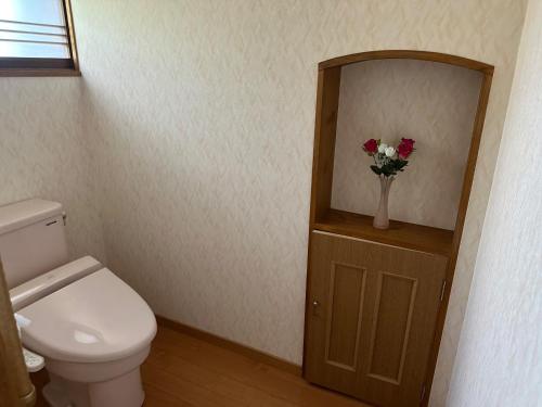 a bathroom with a toilet and a vase of flowers at Minpaku Tanaka - Vacation STAY 15255 in Kyotango