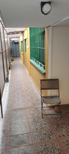 an empty hallway with a chair in a building at Residencial La Nona - Villa Alemana in Villa Alemana