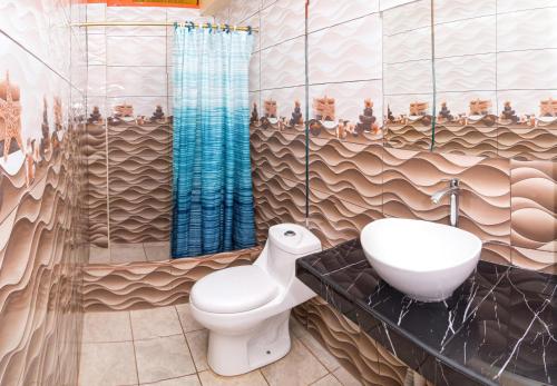een badkamer met een toilet en een wastafel bij Hotel Retamayo in Ica