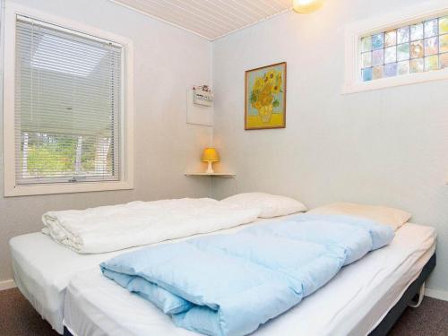 two beds in a room with a window at Two-Bedroom Holiday home in Ans By 2 in Ans