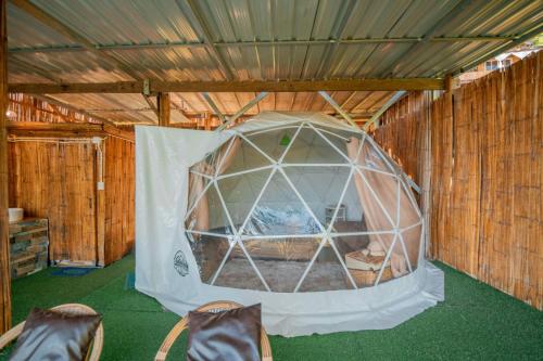 a tent in a room with some chairs in it at บ้านลิ้นจี่โฮมสเตย์ Baan Lychee homestay in Ban Thung Phan Ha