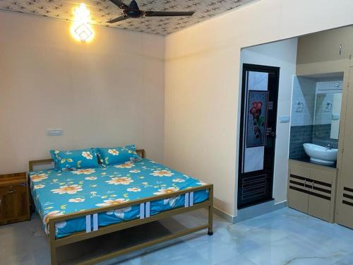 a bedroom with a bed and a bathroom with a sink at Heavenly Stay in Thekkady